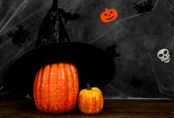 halloween concept with pumpkin with witch hat against dark background. Banner in black and orange...