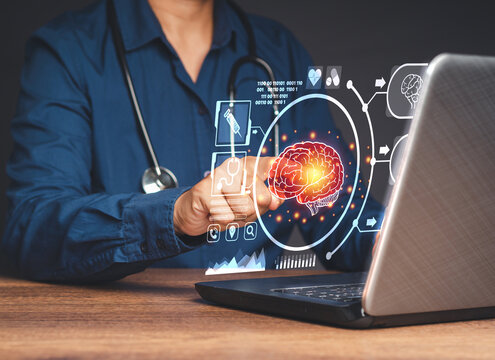 Hand of a doctor touching an image of the brain symbol on a virtual screen while sitting in the hospital