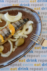 Whole smoked mackerel served with onion and green olives	