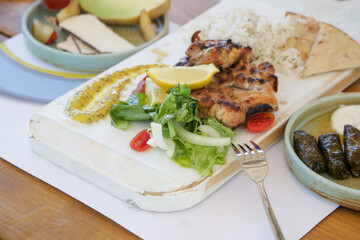 Chicken leg fillet served with green salad, aromatic rice, lemon slices and made in house mustard.	