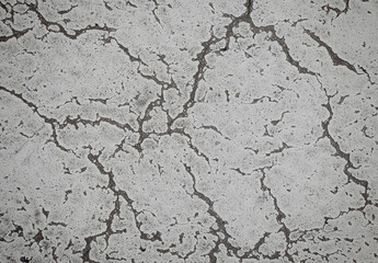 Grunge cracked texture of an old floor. Background of damaged stone