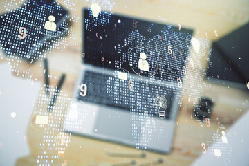 Double exposure of social network icons concept with world map and modern laptop on background. Marketing and promotion concept
