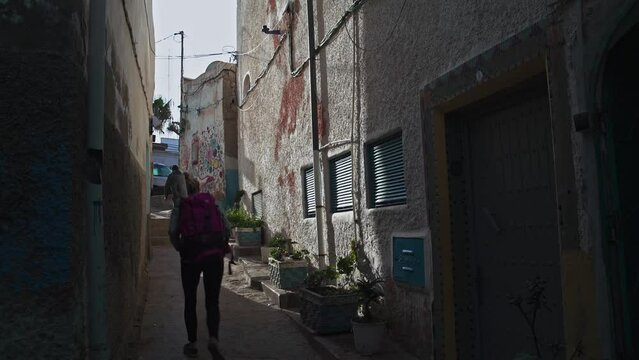 Tourists walking in an alley in Taghazout
