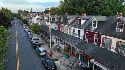 American homes in urban city. Cars parked on street, sidewalk and front porch aerial views.