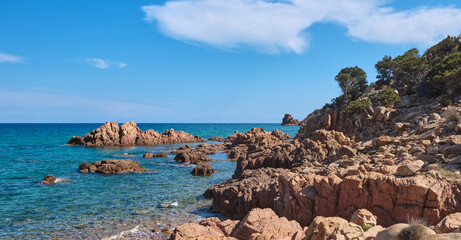 Fototapeta premium The little beach of Su Sirboni has red surfacing rocks - Sardinia - italy