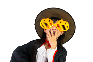 Cute Asian girl smiling and dressed in Halloween themed witch costume on white background.