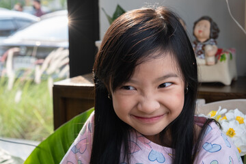 Asian child girl is smiling bright and cute in the home