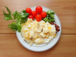 scrambled eggs with vegetables and cheese on a plate