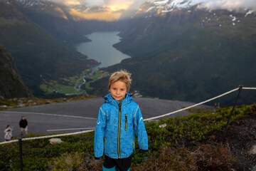 People, adult with kids and pet dog, hiking mount Hoven, enjoying the splendid view over Nordfjord...