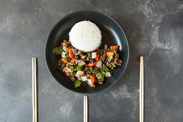 beef meat with vegetables and steamed rice , asian cuisine