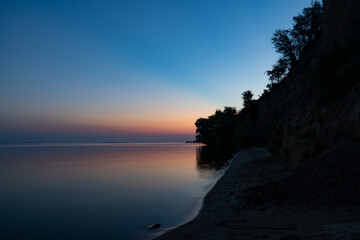 Sunset over the water near the mountains