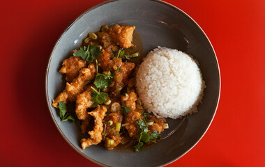 bright fragrant meat pieces and strips in starch batter in Asian style with steamed rice