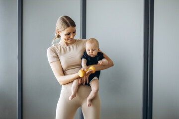 Mother with toddler daughter exercising yoga