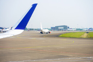 Aircraft traffic activity running on the runway. Planes queue on the runway. No brand.