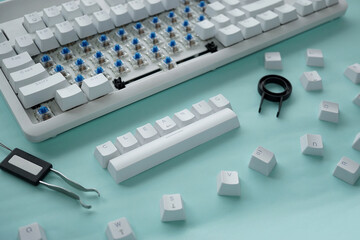 Concept of cleaning disassembled mechanical keyboard game with switch puller and keycaps puller.