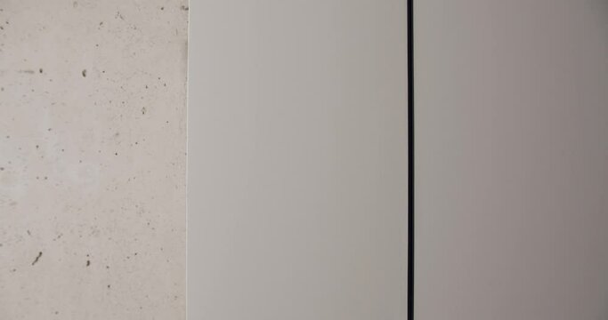 Concrete texture filmed in a minimalist interior, wall in grey tonne . Texture, background