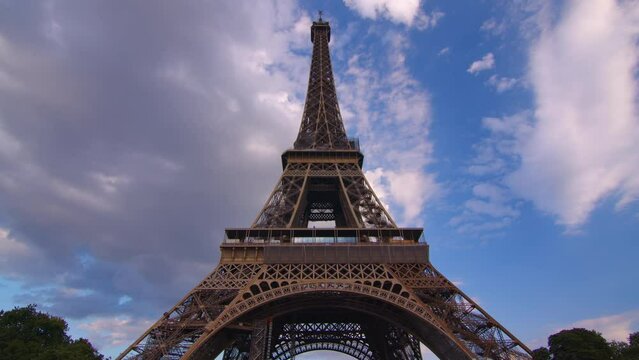 Timelapse, movement of clouds. Sunset, dusk, Eiffel tower, blue sky, top view, paris, 4k, time lapse, France. The most popular tourist attraction in the world.