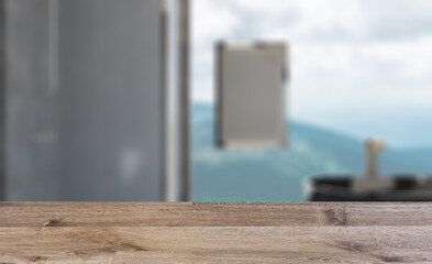 Spacious bathroom in gray tones with heated floors, freestanding. Background with empty wooden table. Flooring.