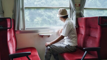 A lonely man traveling by train in Japan.