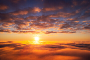 Naklejka na ściany i meble Beautiful landscape above the clouds of setting sun. Aerial photo of sun going under horizon, dream like atmosphere