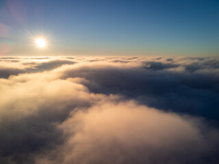 Day photo of plane flying over the clouds. Calm photo above the clouds