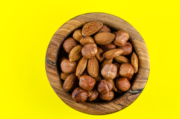 Nuts in assortment in wooden dishes with a place to copy.