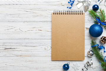 Christmas blank greeting card mock-up scene. Creative layout made of Christmas tree branches and paper card note. Flat lay. Nature New Year concept