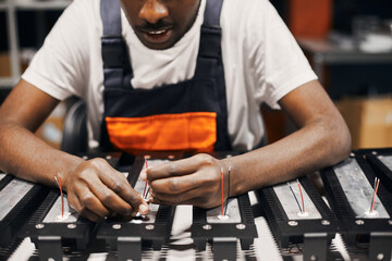Factory worker connecting wires at circuit