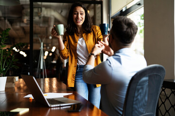Colleagues in office. Businesswoman and businessman drinking coffee..