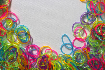 Rubber bands for weaving bracelets. Background with space for text on top.