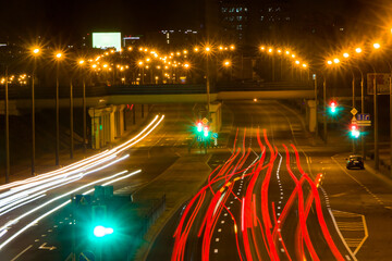 View from the bridge to the night highway with traces of car headlights.