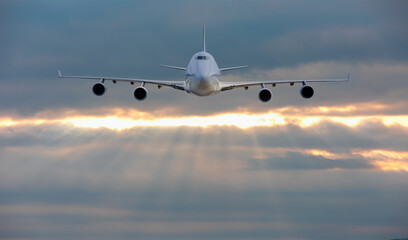 Fototapeta na wymiar Giant airplane in the sky at sunset