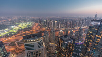 Obraz premium Panorama of Dubai Marina with JLT skyscrapers and golf course day to night timelapse, Dubai, United Arab Emirates.