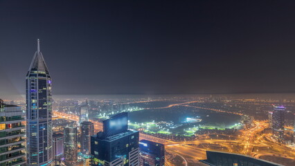 Aerial skyline with Golf Club, hotels and residential areas far away in desert in Dubai all night timelapse, UAE, top view