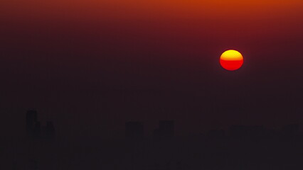 Sunrise close up view over Dubai skyline in the morning, aerial top view from Dubai marina timelapse.