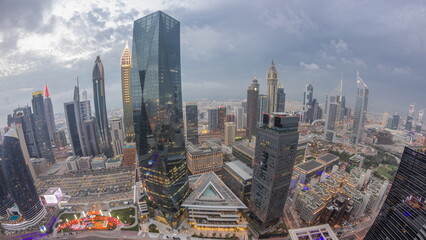 Obraz premium Panorama of futuristic skyscrapers after sunset in financial district business center in Dubai day to night timelapse
