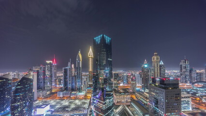 Obraz na płótnie Canvas Panorama of futuristic skyscrapers in financial district business center in Dubai all night timelapse