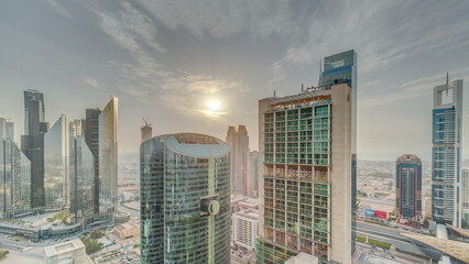 Sunset over Dubai international financial center skyscrapers aerial timelapse.