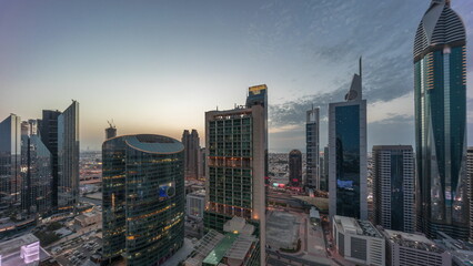 Obraz premium Dubai international financial center skyscrapers aerial day to night timelapse.