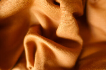 Simple brownish orange hemp and cotton fabric in soft folds