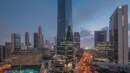 Fototapeta na wymiar Dubai International Financial district aerial night to day timelapse. Panoramic view of business office towers.