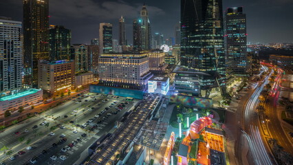 Fototapeta premium Panorama showing Dubai International Financial district aerial night timelapse. View of business and financial office towers.