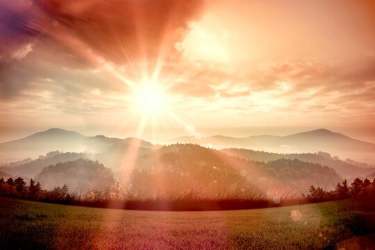 Sun shining over mountains © vectorfusionart