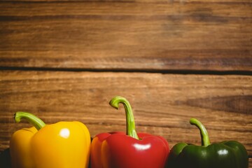 Multi colored bell peppers on chopping board