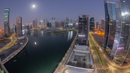 Fototapeta na wymiar Cityscape panorama of skyscrapers in Dubai Business Bay with water canal aerial night to day timelapse