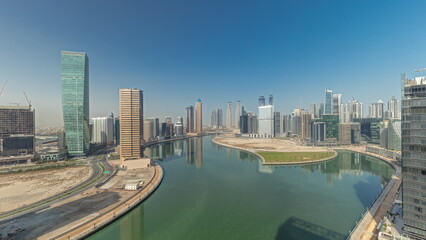 Fototapeta premium Cityscape skyscrapers of Dubai Business Bay with water canal aerial timelapse.