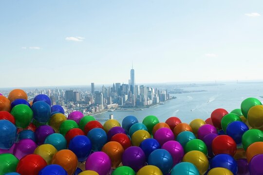 Many colourful balloons against coast