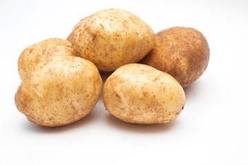 Fresh yellow raw potatoes on a white background