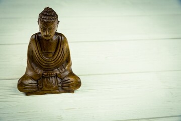 Buddha statue on wooden floor