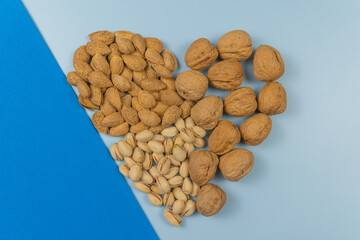 natural and healthy nuts with heart shape and blue background
